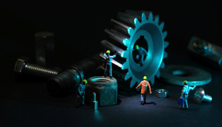 A photograph of miniture figures working on railcar parts